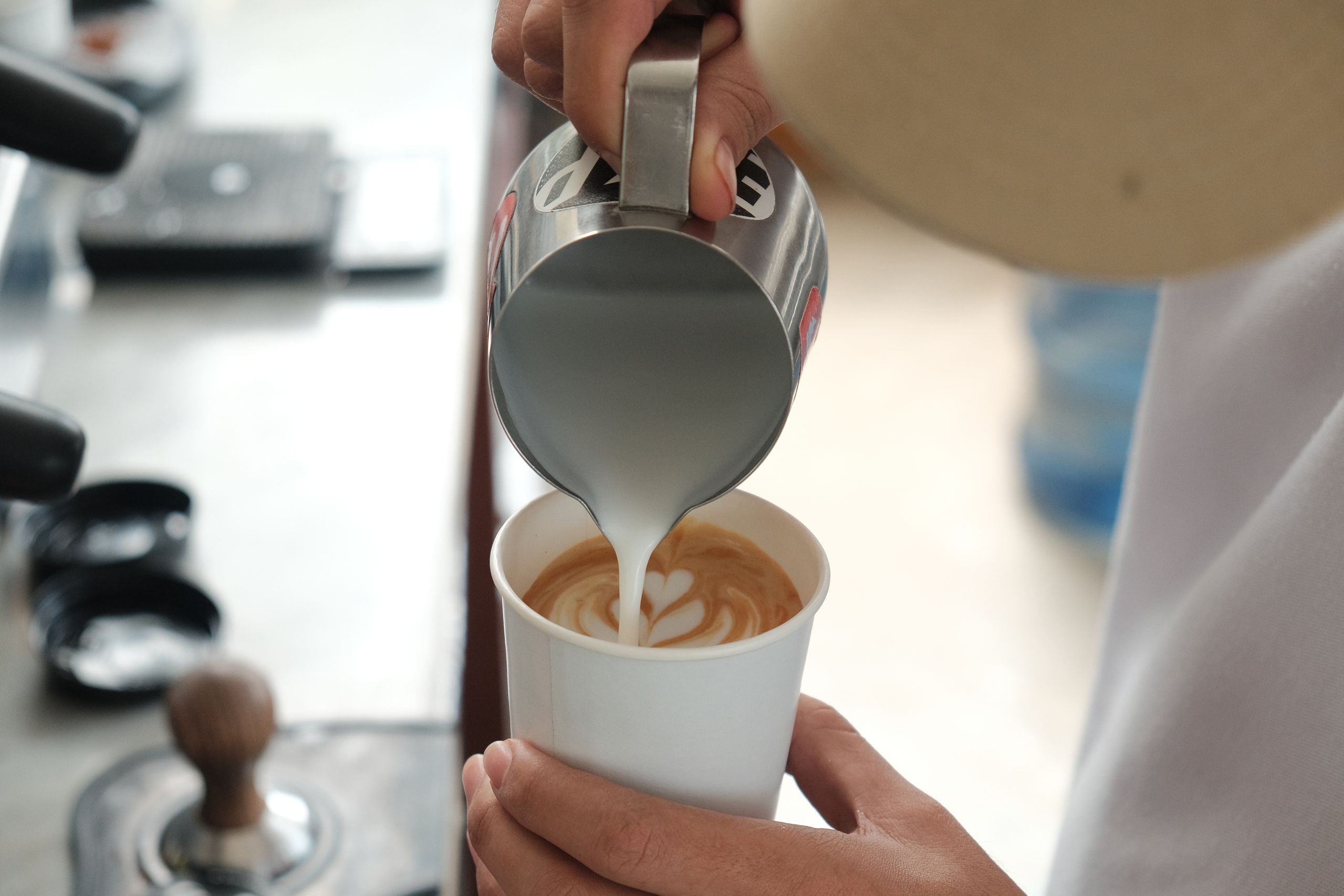 Barista pouring latte art